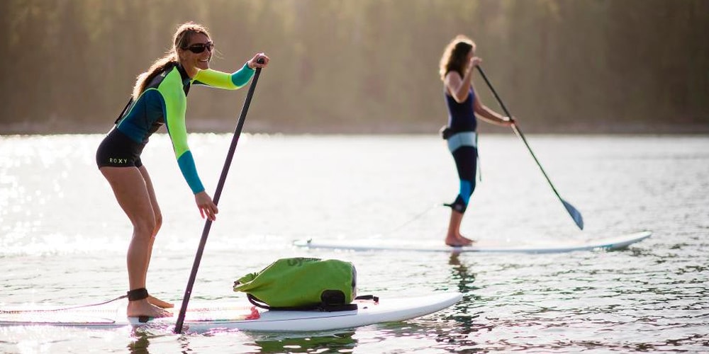 Two ladies Stand Up Paddleboarding