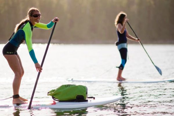 Two ladies Stand Up Paddleboarding